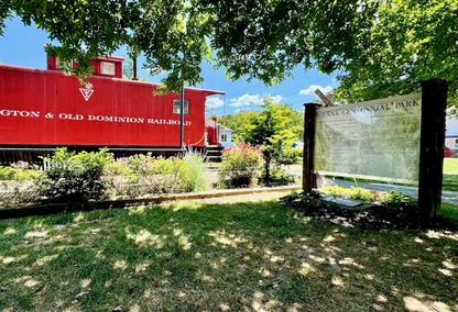 red railroad station with park sign